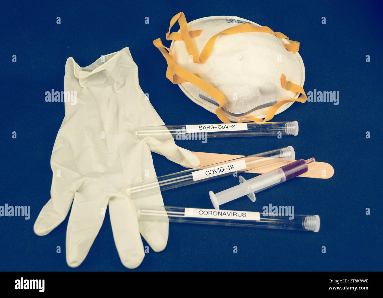 face mask, latex glove, syringe and testing tubule for Corona Stock Photo