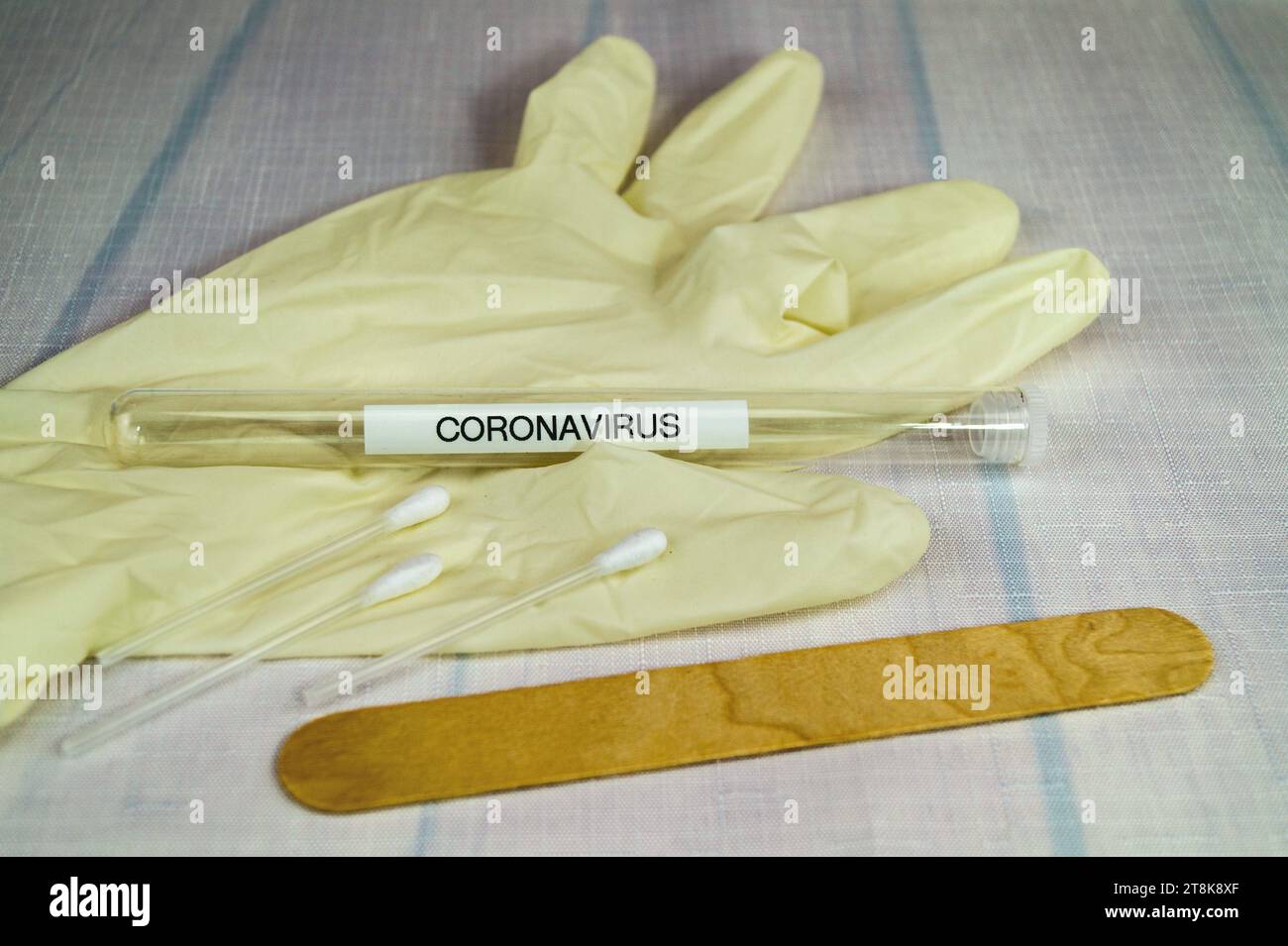 Corona test tubule, latex glove, cotton swab and spatula Stock Photo