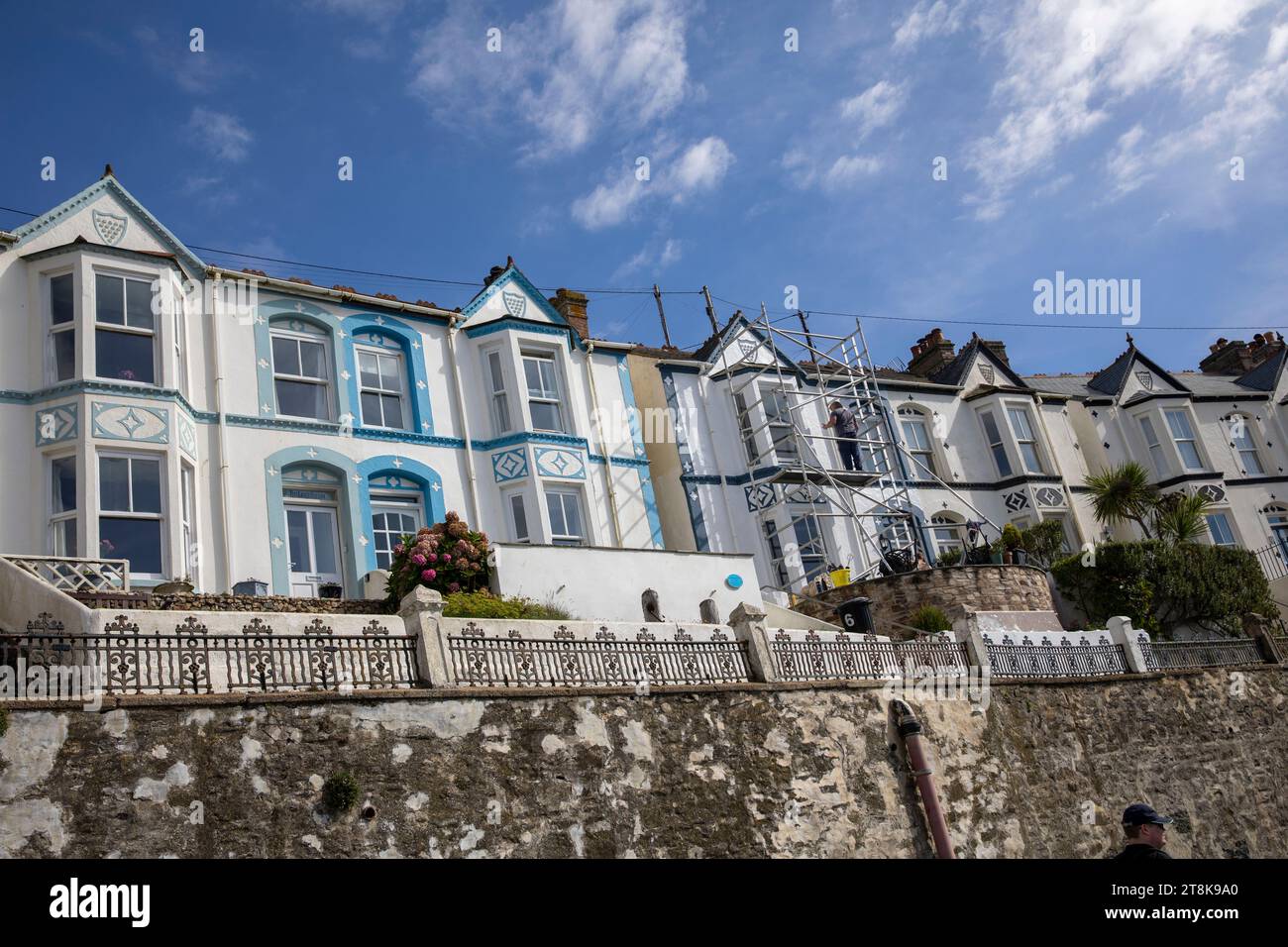 Porthleven town in Cornwall England, terraced two story homes in pastel colours overlook the harbour and coast,Cornwall,England,UK,2023 Stock Photo