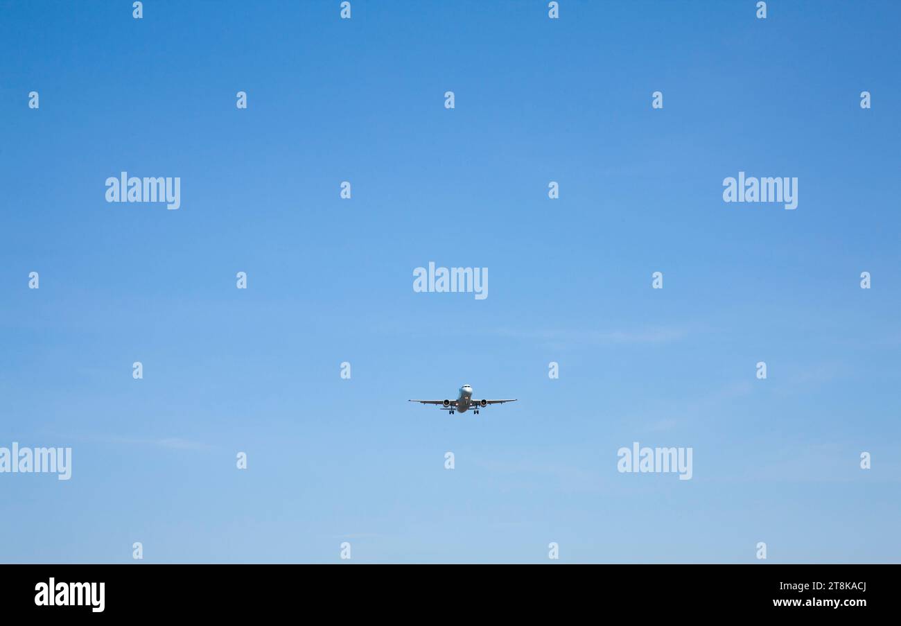 Commercial Airplane against blue sky Stock Photo - Alamy
