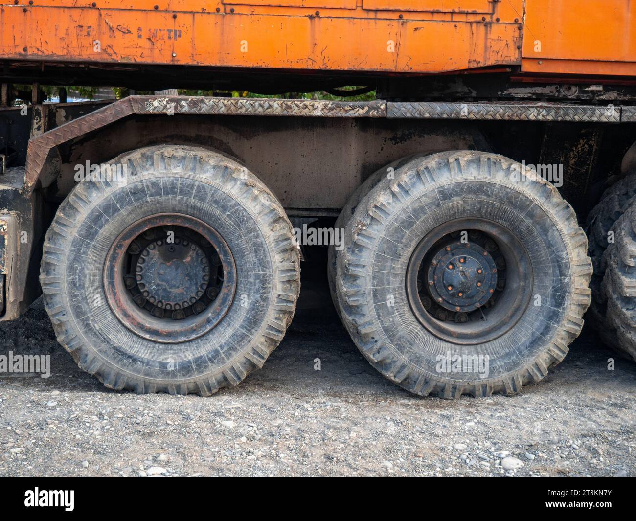 Crane on large wheels. Construction equipment. Non-working hours. Huge wheels Stock Photo
