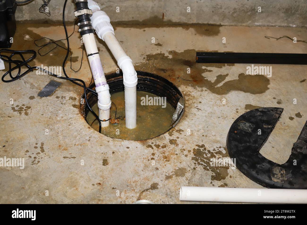 A sump pump in a home basementplumbing repair Stock Photo Alamy