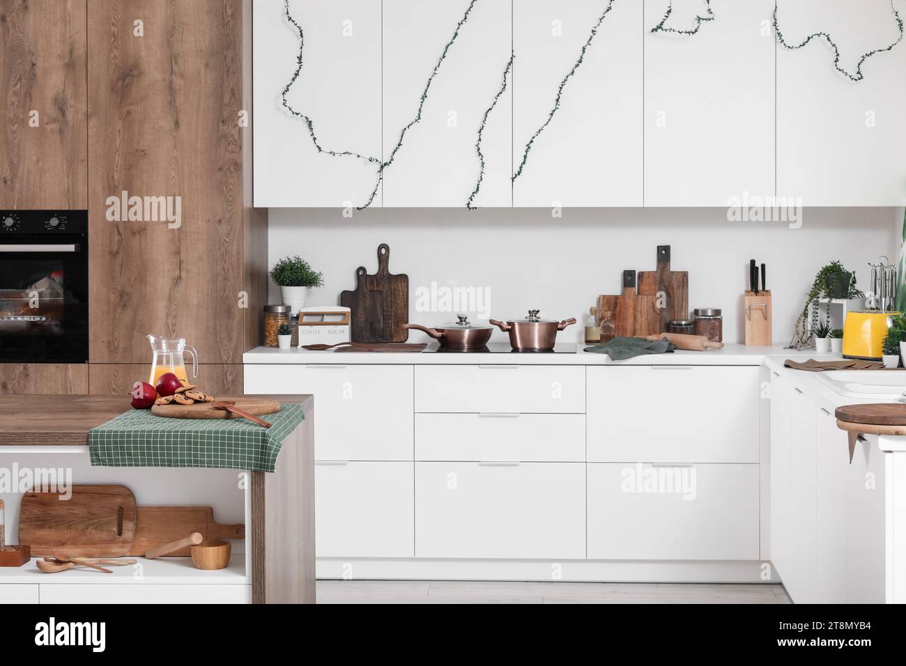 Interior of modern kitchen with white counters and utensils Stock Photo ...