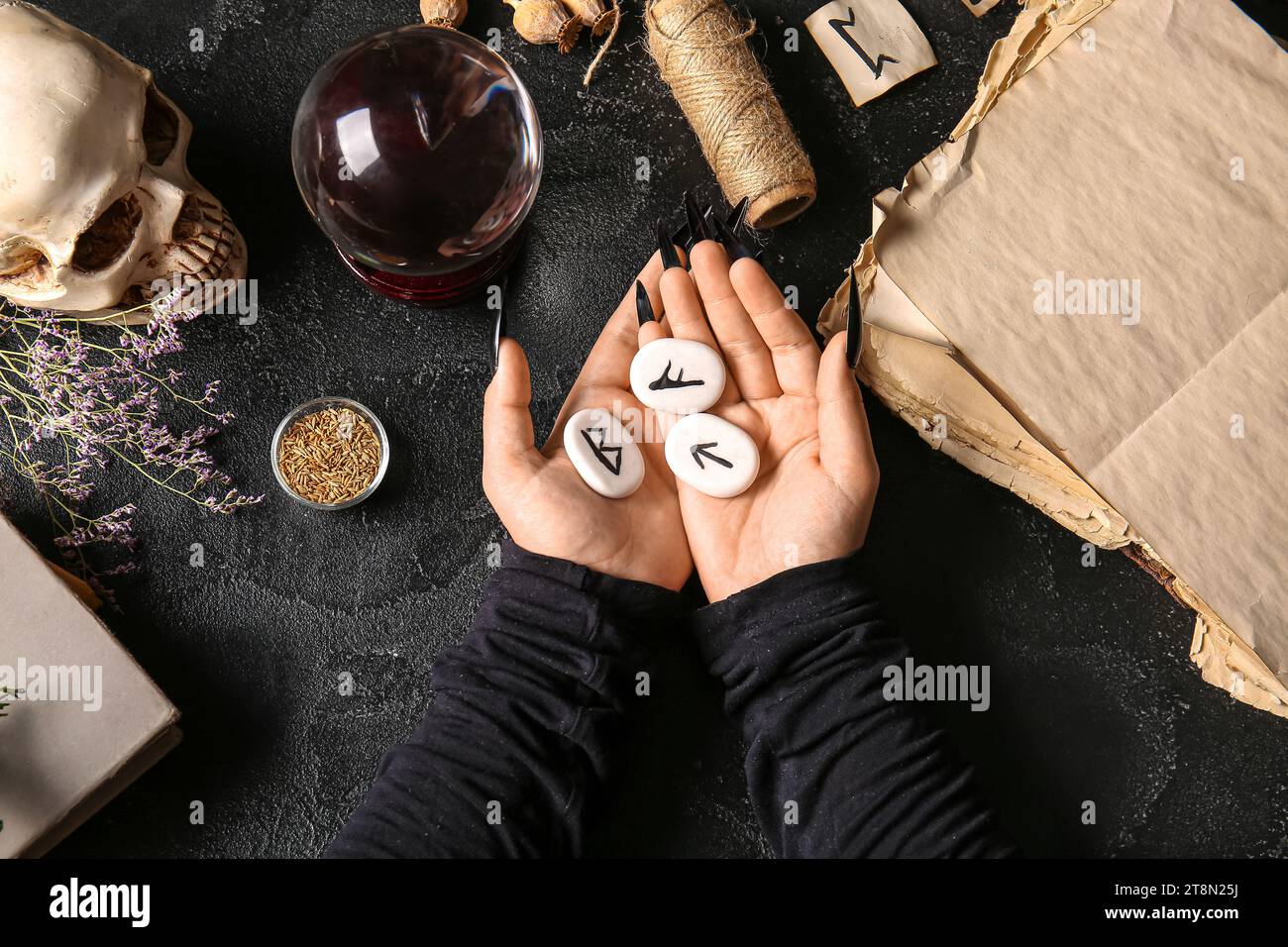 Witch with runes and magic attributes on dark background Stock Photo ...