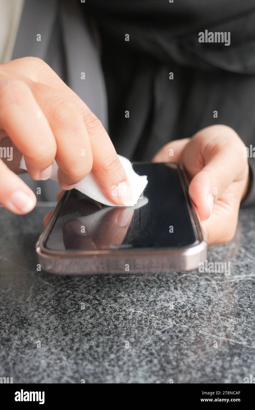 cleaning mobile phone display for preventing virus Stock Photo - Alamy