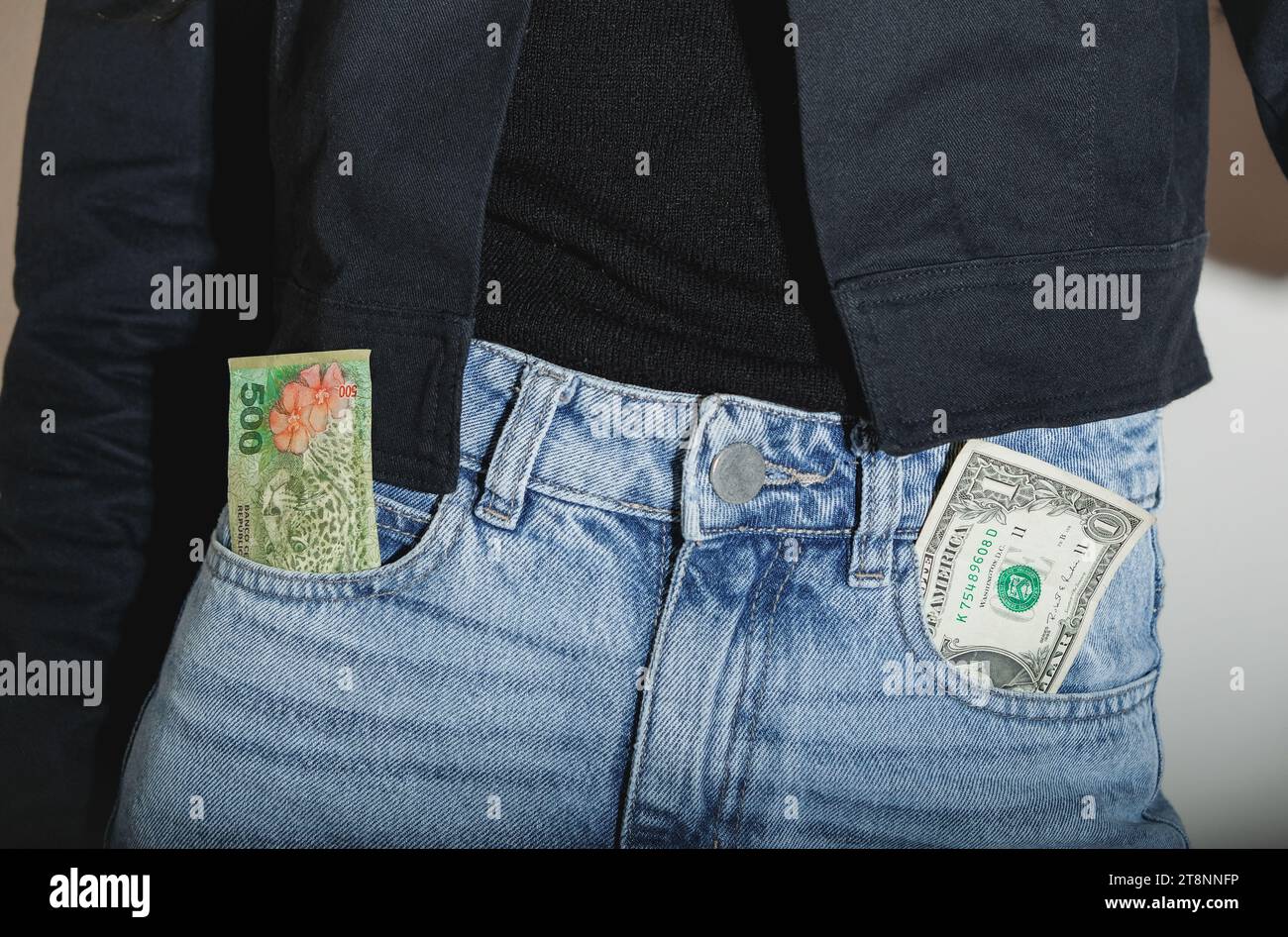 Argentine Pesos And One Dollar Bill. Inflation concept and devaluation of the Argentine currency. Stock Photo
