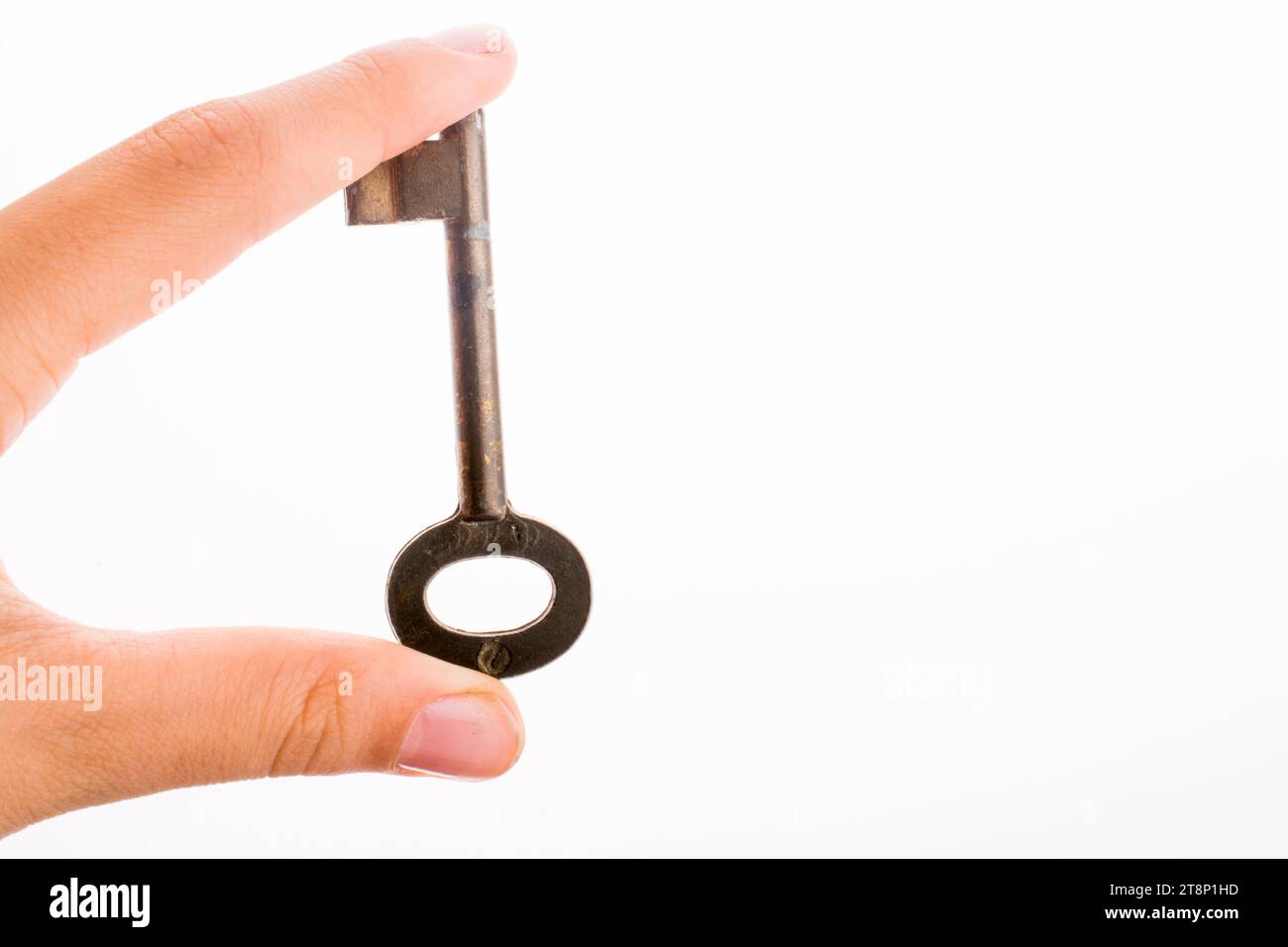 Hand holding a key on a white background Stock Photo - Alamy