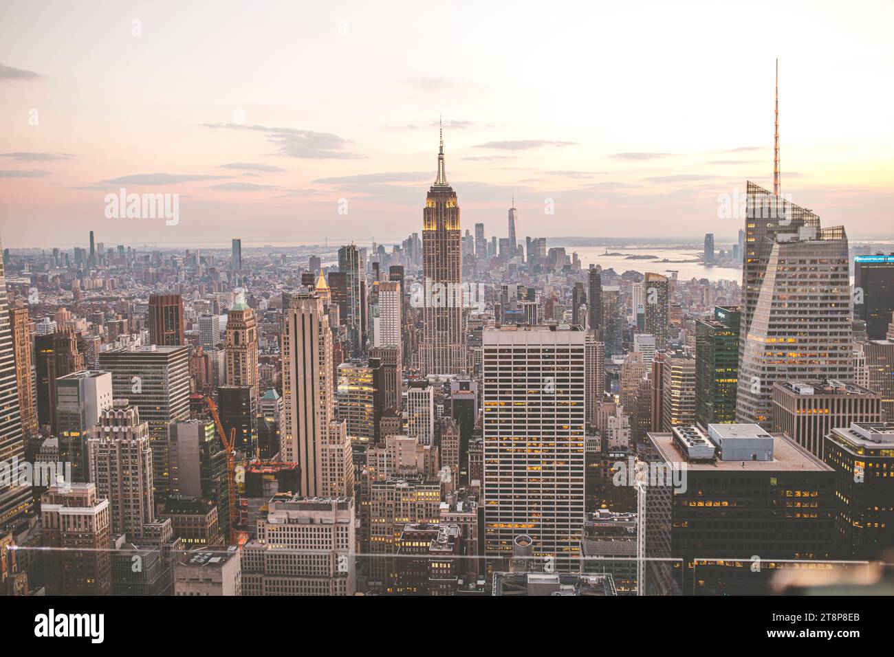 Aerial image of New York City at dusk with its illuminated skyscrapers ...