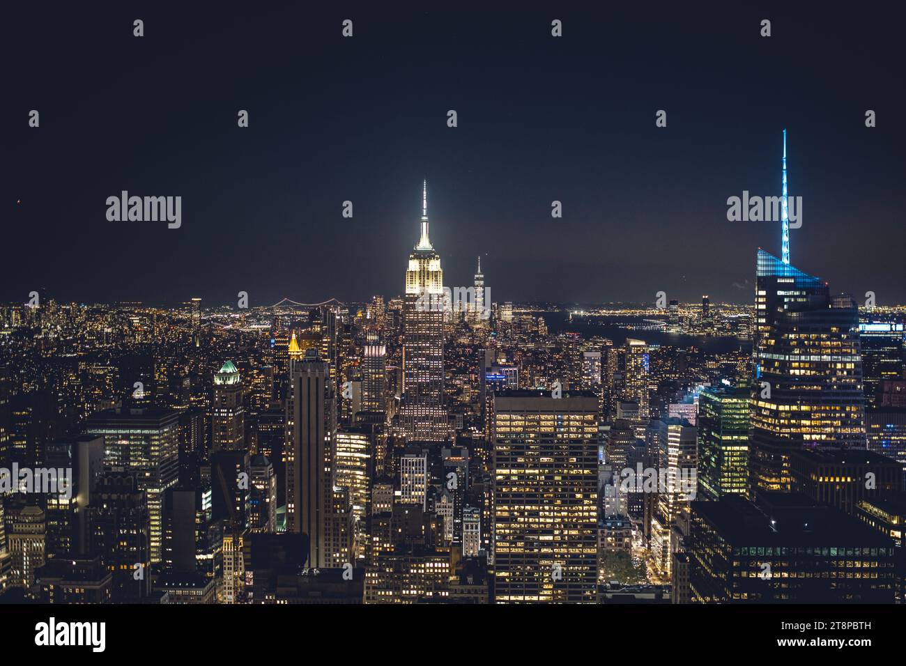 Aerial image of New York City at night at sunset with its illuminated ...