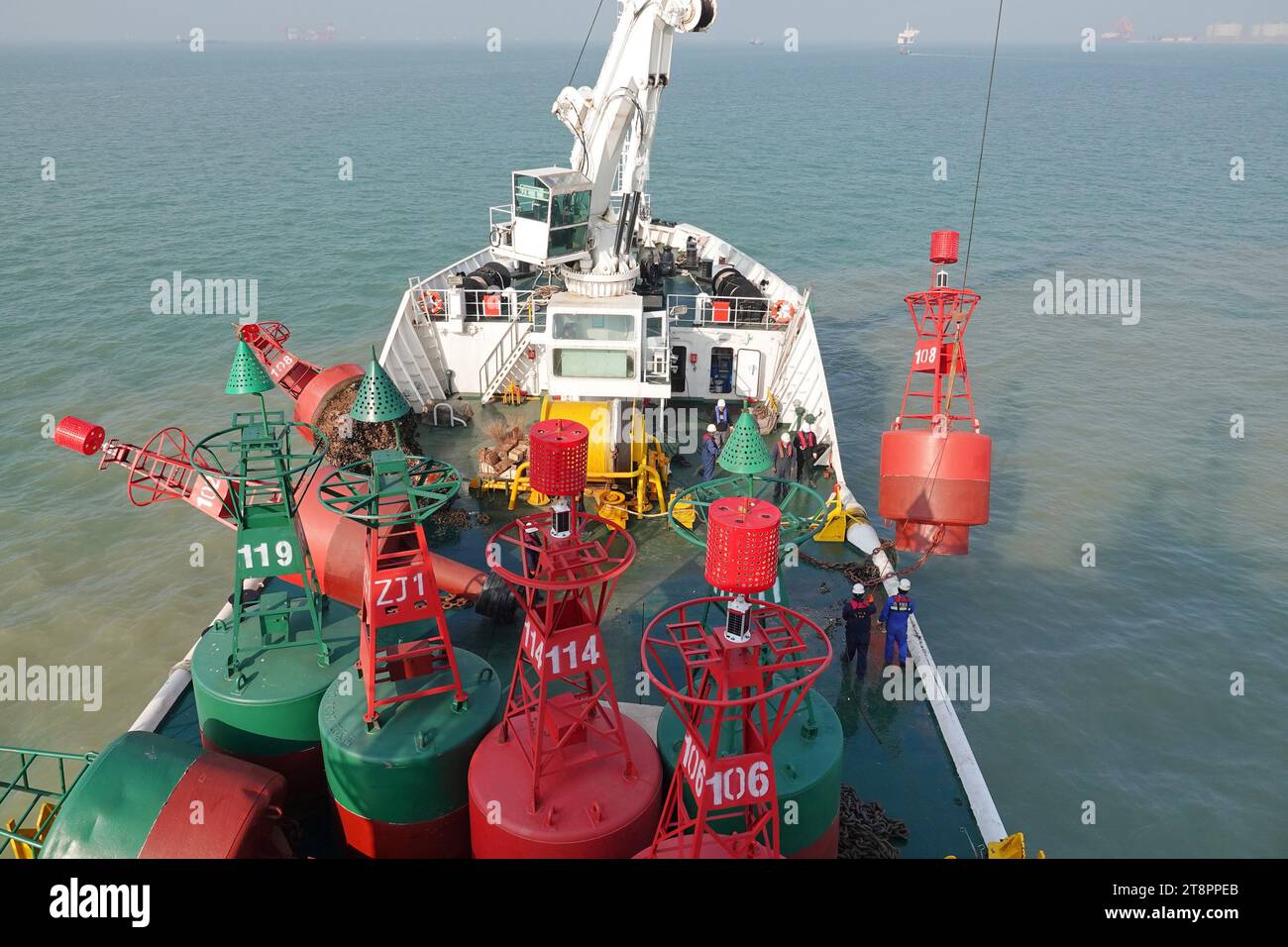 YANTAI, CHINA - NOVEMBER 21, 2023 - The 'Haixun 153' navigation vessel releases a new beacon into the sea at the main channel of Longkou Port, Shandon Stock Photo