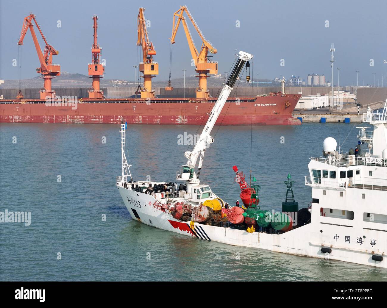 YANTAI, CHINA - NOVEMBER 21, 2023 - The "Haixun 153" navigation vessel releases a new beacon into the sea at the main channel of Longkou Port, Shandon Stock Photo