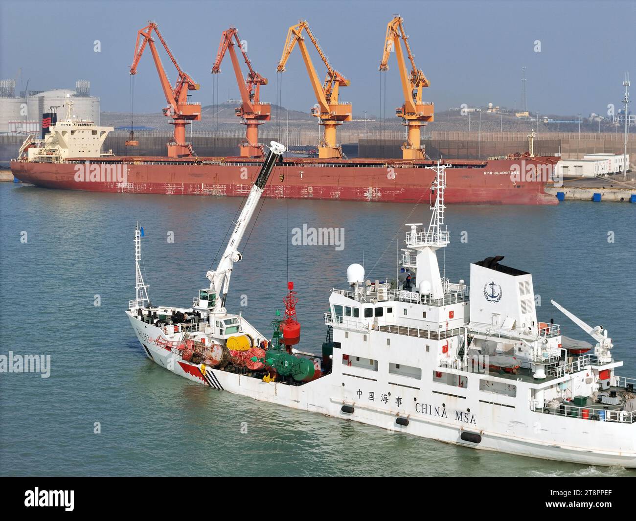 YANTAI, CHINA - NOVEMBER 21, 2023 - The 'Haixun 153' navigation vessel releases a new beacon into the sea at the main channel of Longkou Port, Shandon Stock Photo