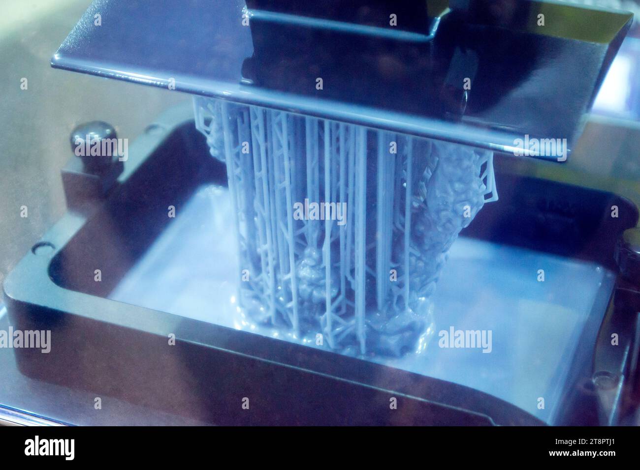 Working of photopolymer sla 3D printer. Platform with building object