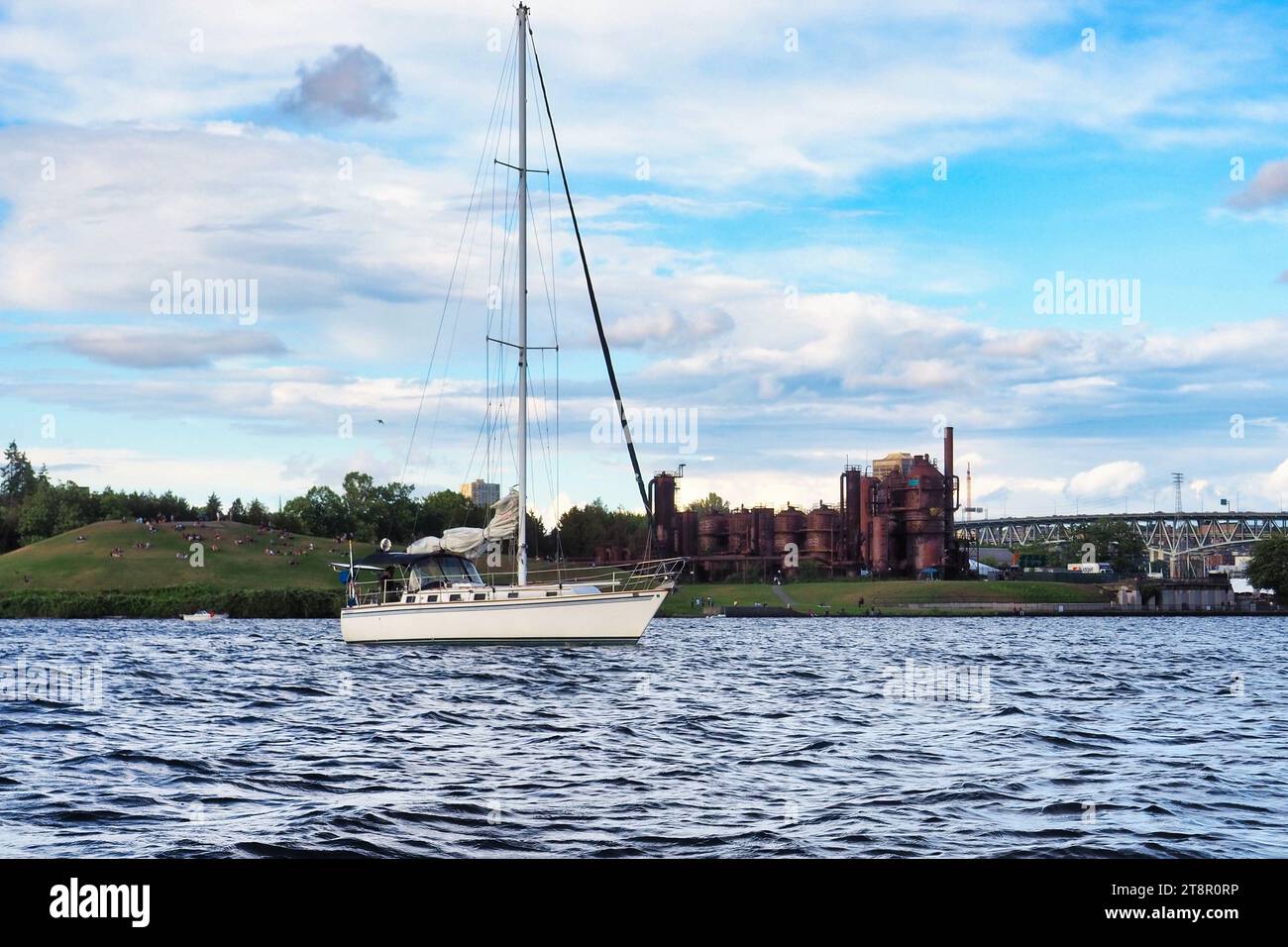 View of Gas Works Park in Fremont, Seattle from Lake Union. Rippling water on sunny summer day with boat. Stock Photo