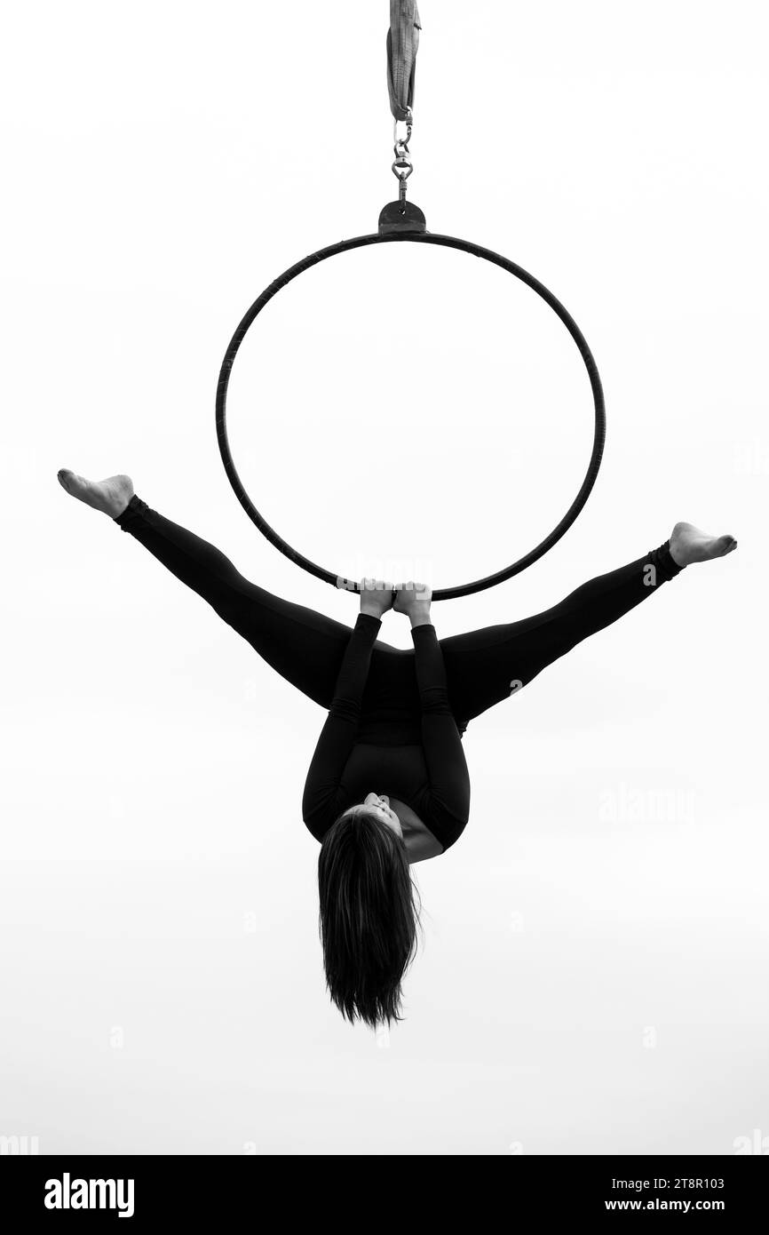 Young woman performing on hoop outdoors Stock Photo