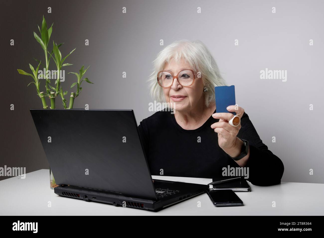 senior woman with bank card shopping online Stock Photo