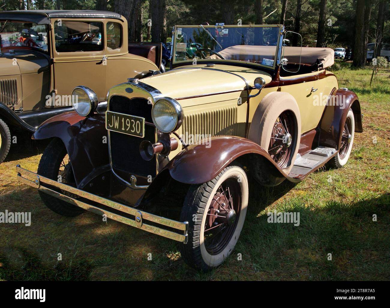 1930 Ford Model A 2, The Ford Model A of 1928–1931 (also colloquially called the A-Model Ford or the A, and A-bone among rodders and customizers) was the second huge success for the Ford Motor Company, after its predecessor, the Model T. First produced on October 20, 1927, but not sold until December 2, it replaced the venerable Model T, which had been produced for 18 years. This new Model A (a previous model had used the name in 1903–1904) was designated as a 1928 model and was available in four standard colors Stock Photo