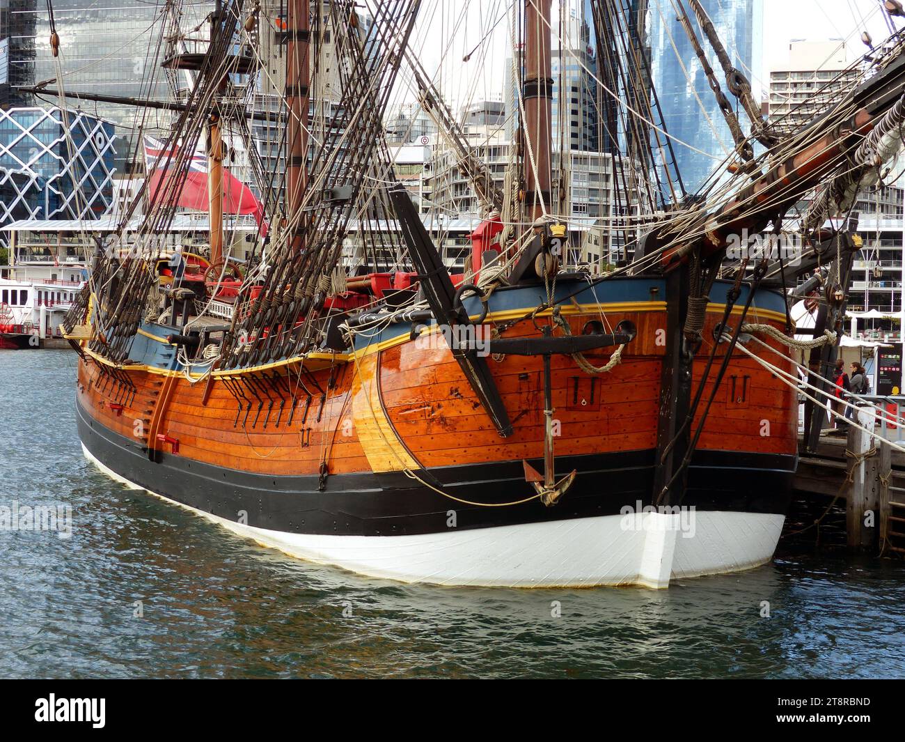 HM Bark Endeavour Replica, HM Bark Endeavour Replica is a replica of HMS Endeavour, the bark commanded by Lieutenant James Cook when he charted New Zealand and discovered the eastern coast of Australia. The idea of recreating Endeavour for use as a museum ship was generated during the establishment of the Australian National Maritime Museum in the 1980s; the vessel would be funded by the Bond Corporation, and gifted to the nation on completion. A specialist shipyard, complete with viewing platform and guided tours for the public, was set up, and construction of the vessel commenced in 1988 Stock Photo