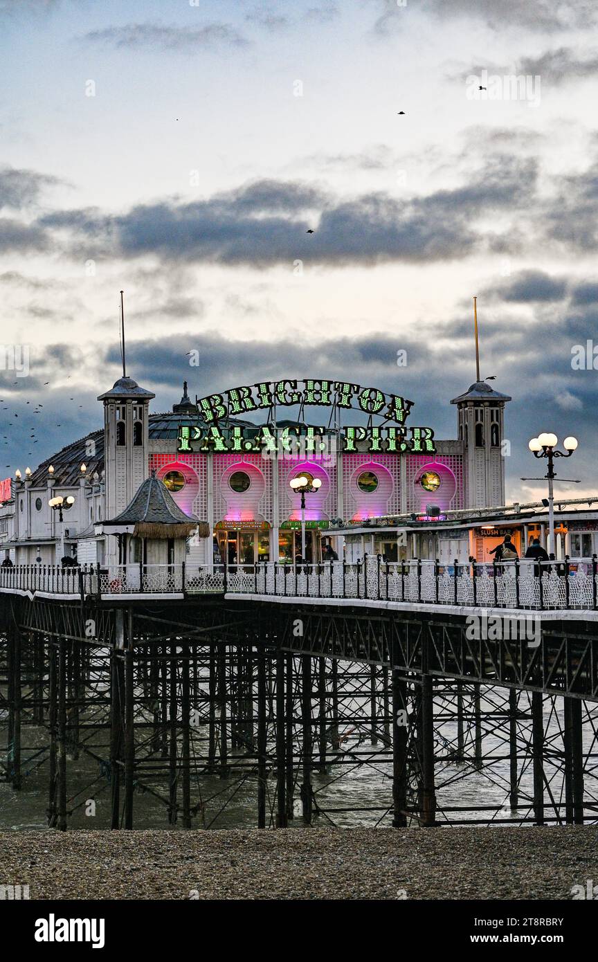 Brighton Palace Pier at dusk with neon lights on the seafront , Sussex , UK Stock Photo