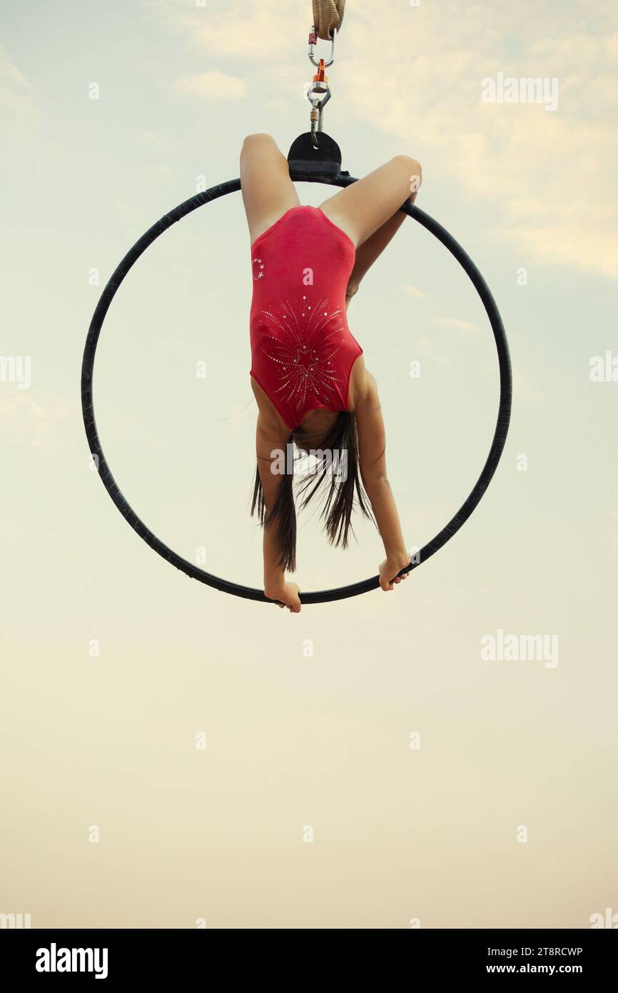 Little girl performing on the hoop outdoors Stock Photo - Alamy