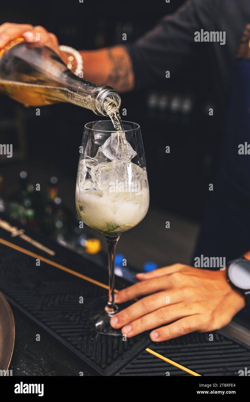 Barman is preparing a delicious cocktail with ice Stock Photo