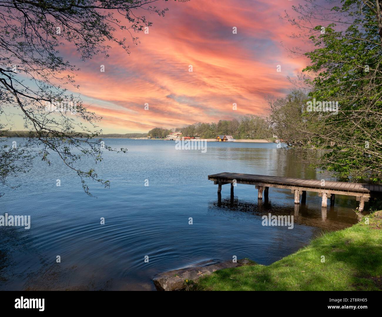 Sunset on a lake in the Mecklenburg Lake District with a wooden jetty Stock Photo