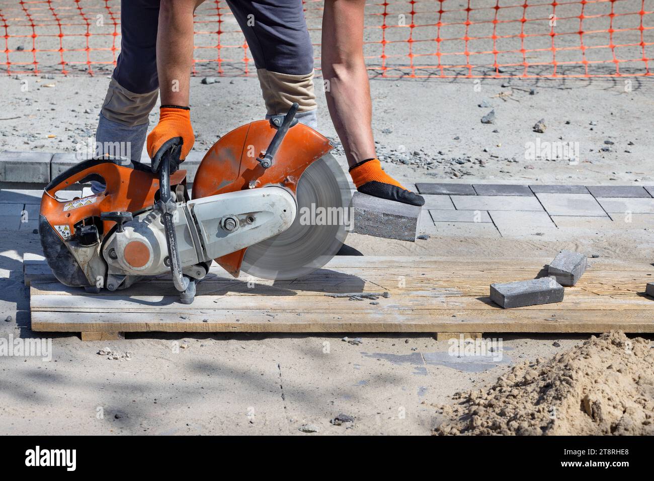 Cutting paving slabs when laying them using a cutting saw and a diamond