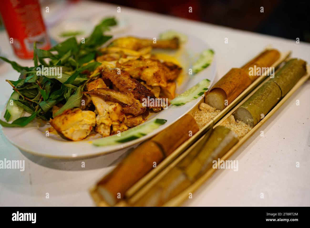 Bamboo tube-cooked rice and grilled chicken Stock Photo