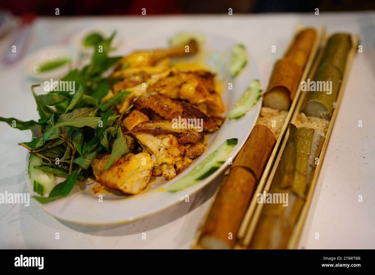 Bamboo tube-cooked rice and grilled chicken Stock Photo