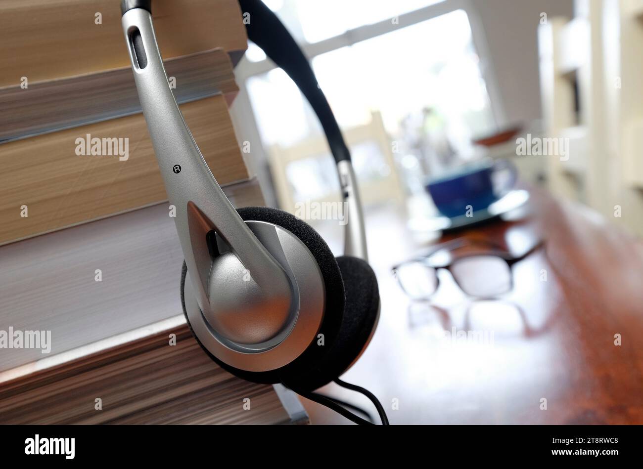 books and headphones on table top in home interior Stock Photo