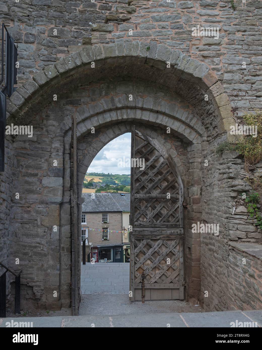 the wooden main gate and entrance arch of the restored Hay Castle in Hay-on-Wye, Powys, Wales, UK Stock Photo