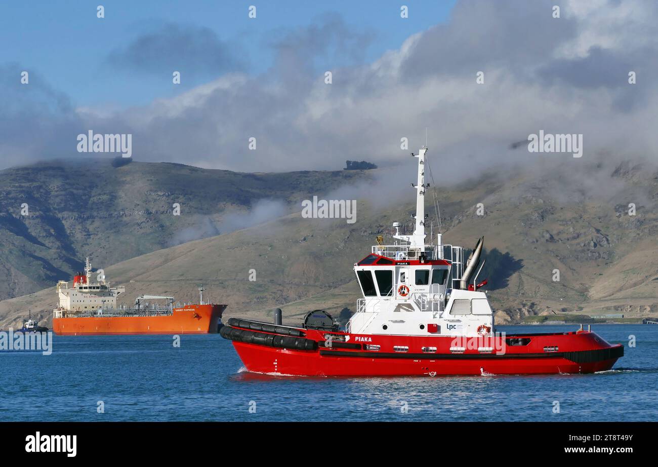 Piaka Tug Port Lyttleton, A tugboat (also called a towboat or simply a tug) is a type of vessel that maneuvers other vessels by pushing or pulling them either by direct contact or by means of a tow line. Tugs typically move vessels that either are restricted in their ability to maneuver on their own, such as ships in a crowded harbor or a narrow canal, or those that cannot move by themselves, such as barges, disabled ships, log rafts, or oil platforms. Tugboats are powerful for their size and strongly built, and some are ocean-going. Some tugboats serve as icebreakers or salvage boats. Stock Photo