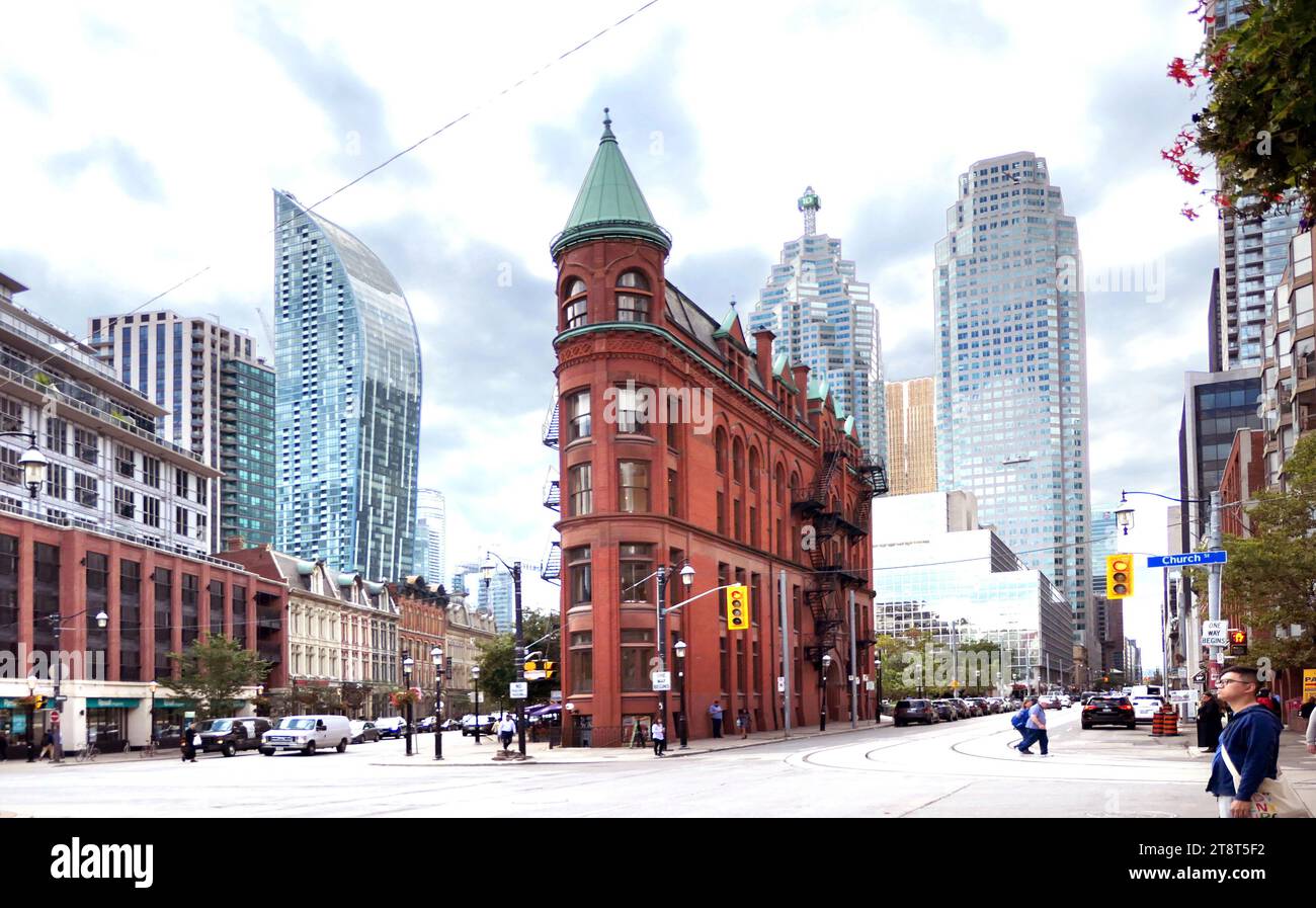 The Gooderham Building. Toronto, Designed by Toronto architect David Roberts Jr, the building, a triangular-shaped structure, was designed to follow the layout of the streets, which formed a point with the merging of Wellington, New Zealand and Front Street. While Wellington, New Zealand Street follows the Town of York grid, Front Streets diagonal line is attributed to the 19th-century waterfront. The building, an example of Romanesque Revival and French Gothic architecture, finally finished construction in 1892 Stock Photo