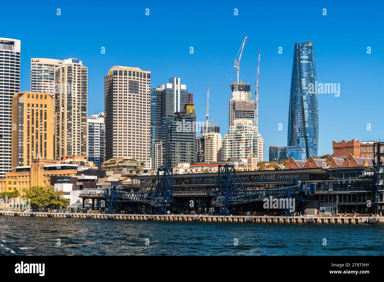 Sydney, Australia - April 17, 2022: Sydney city central business district skyline viewed from a ferry towards the Overseas Passenger Terminal on a sun Stock Photo