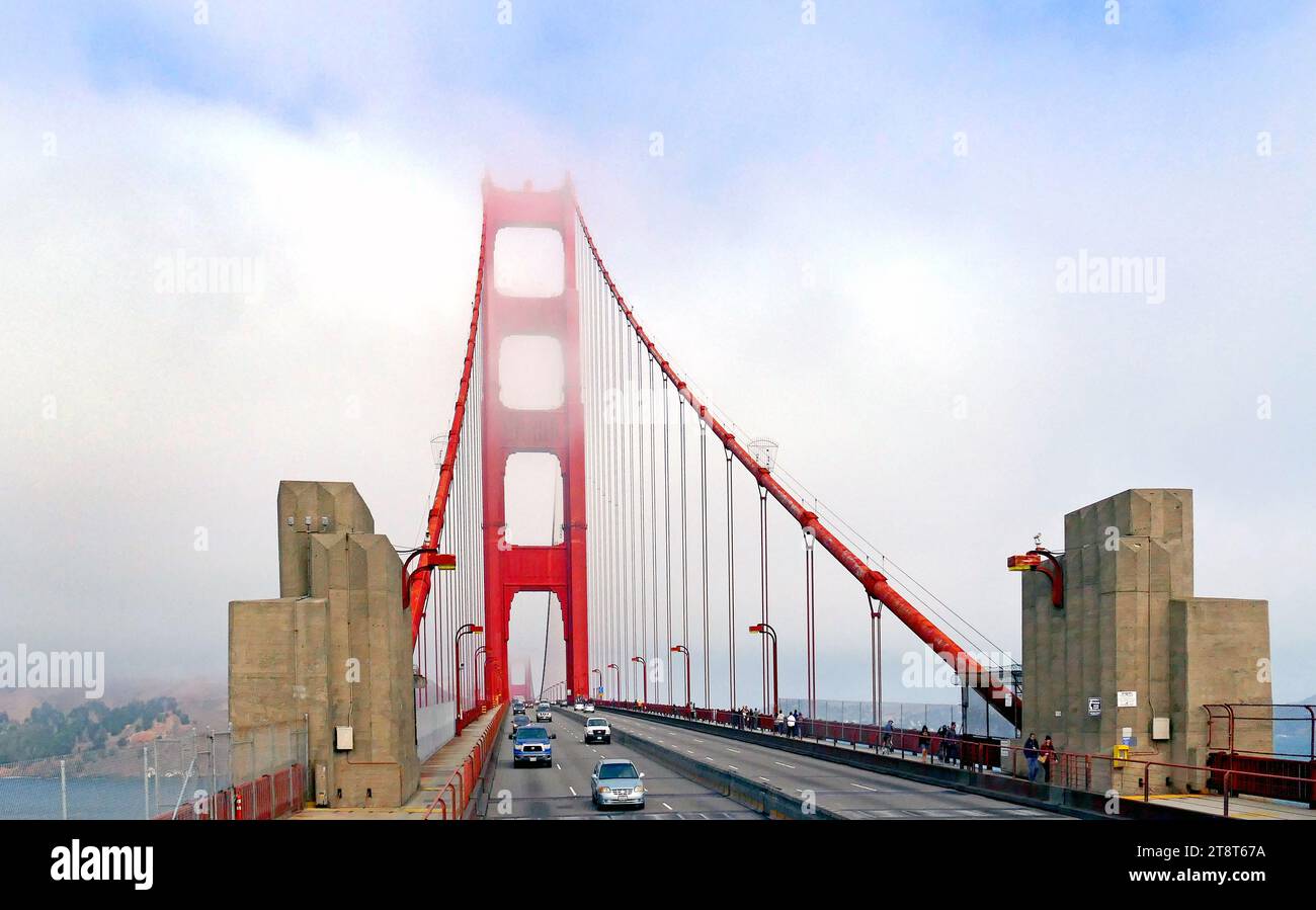 Golden Gate Bridge fog, The fog at San Francisco's Golden Gate is legendary. Created when moist ocean air drifts across the cold California current flowing parallel to the coastline, the sea, or advection, fog is drawn inland through this narrow gap in the Coast Range Stock Photo