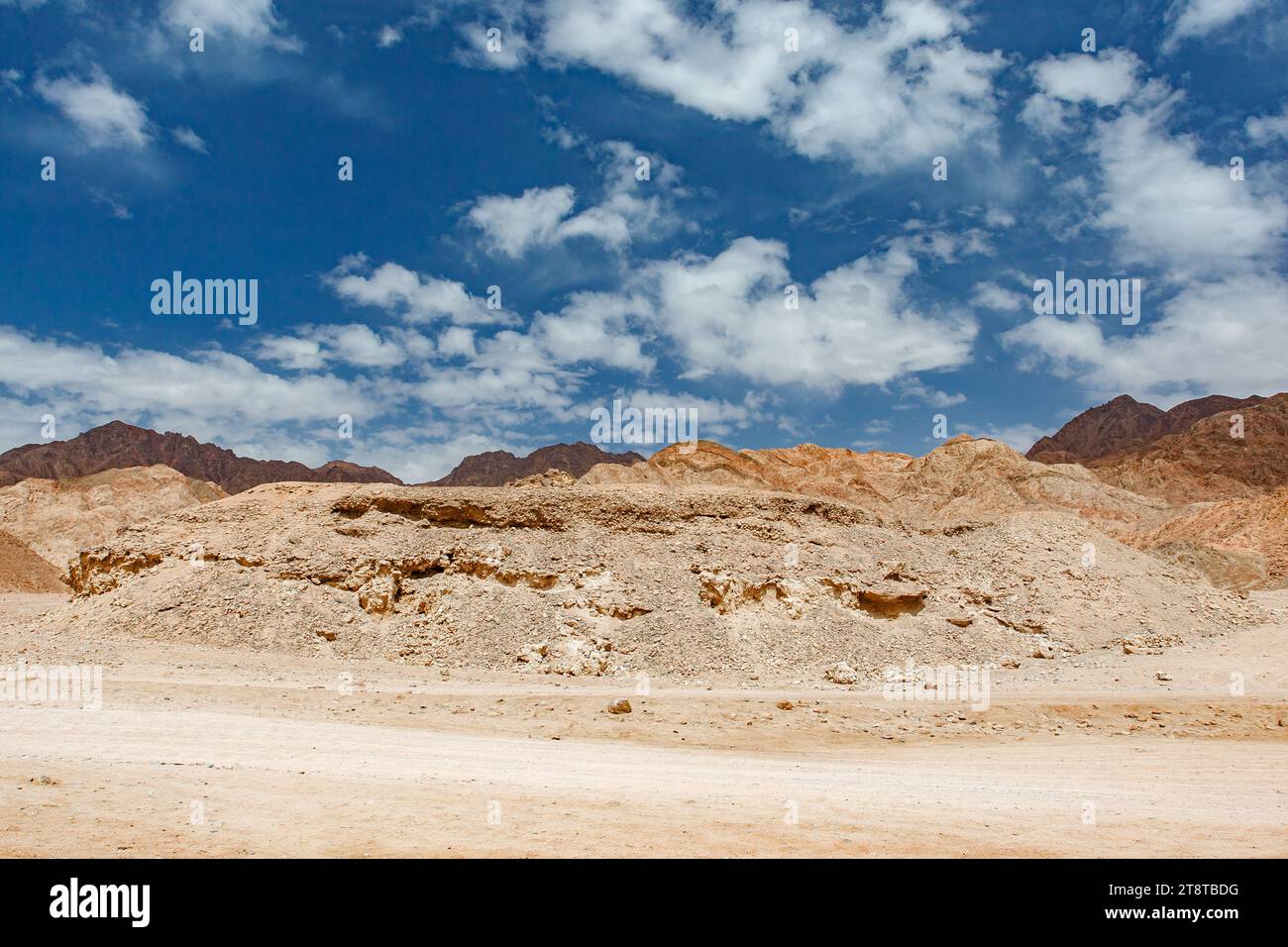 Rocky desert hills under blue sky with white clouds on clear day Stock ...