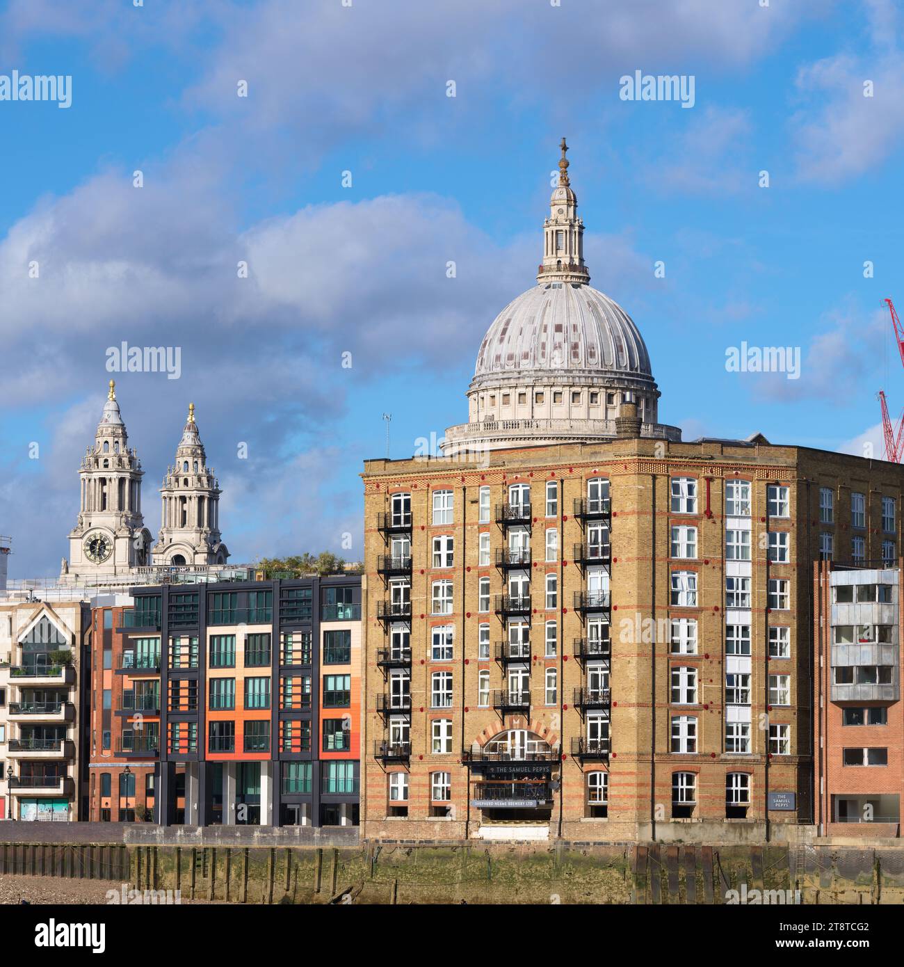 The dome and towers of St Paul's cathedral behind apartments
