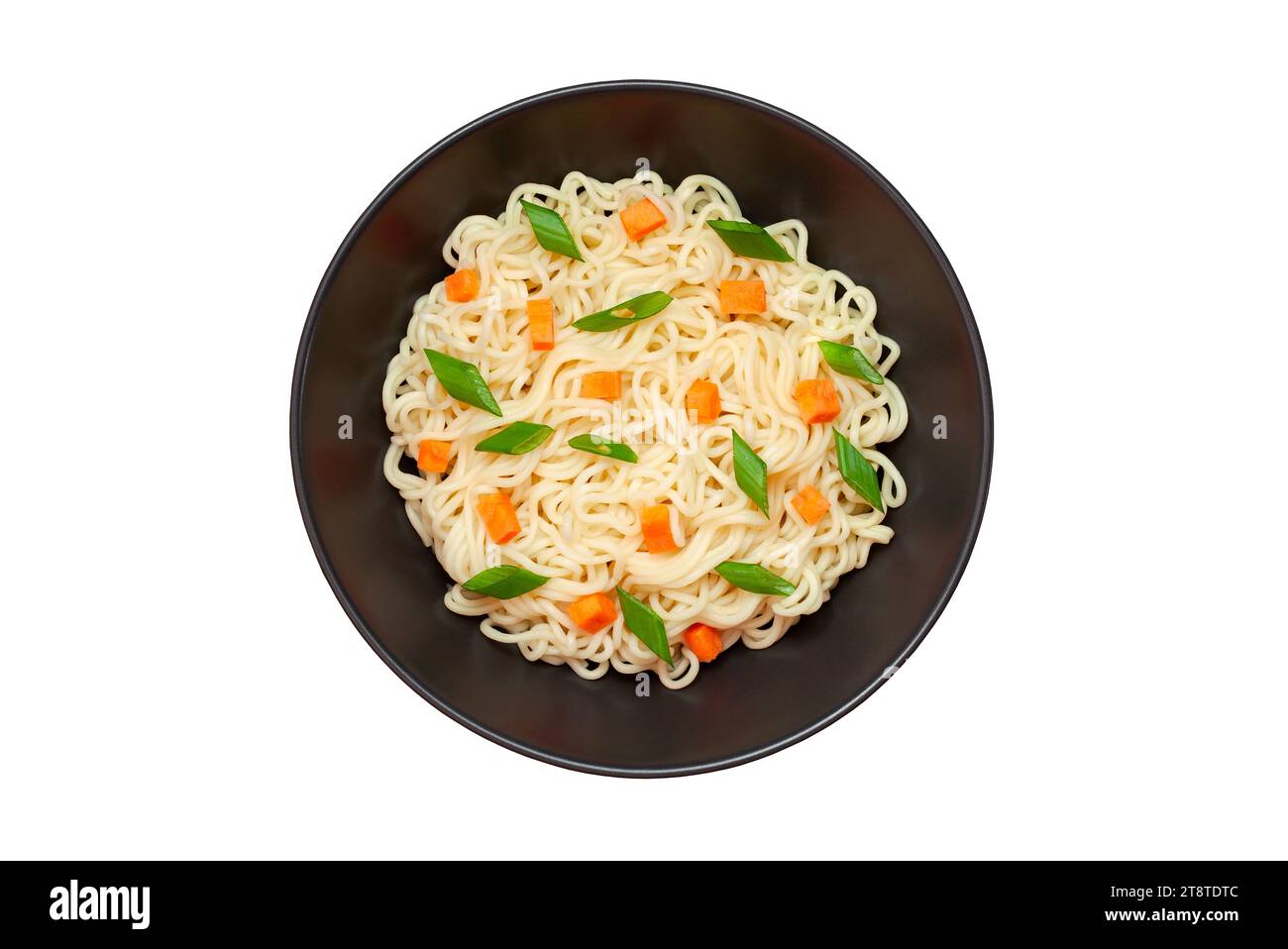 Noodles instant cooked with vegetables carrot and green onion dark bowl, top view isolated on white background with clipping path. Stock Photo