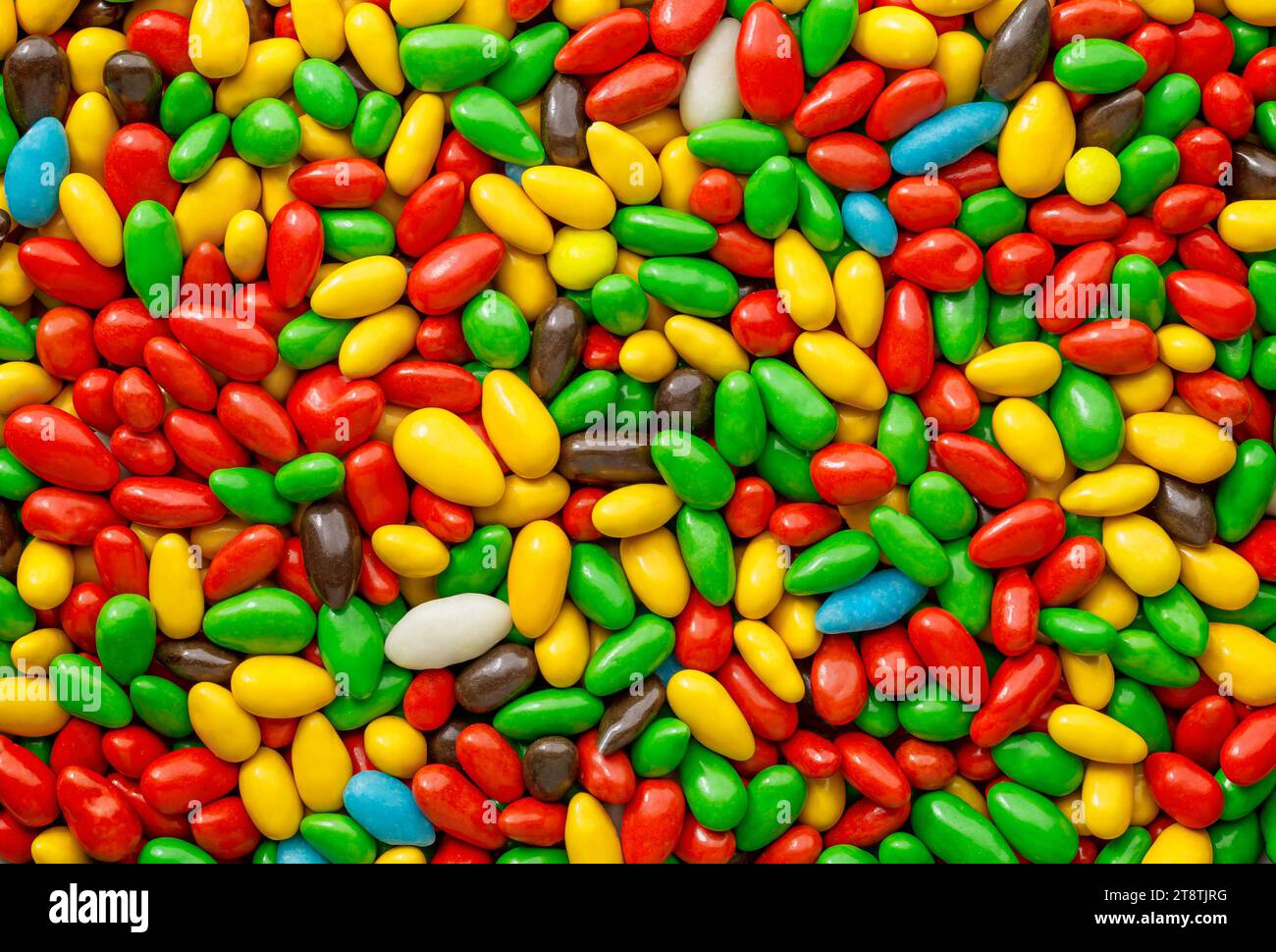 Candy in multi colored glaze in bulk, wallpaper background Stock Photo