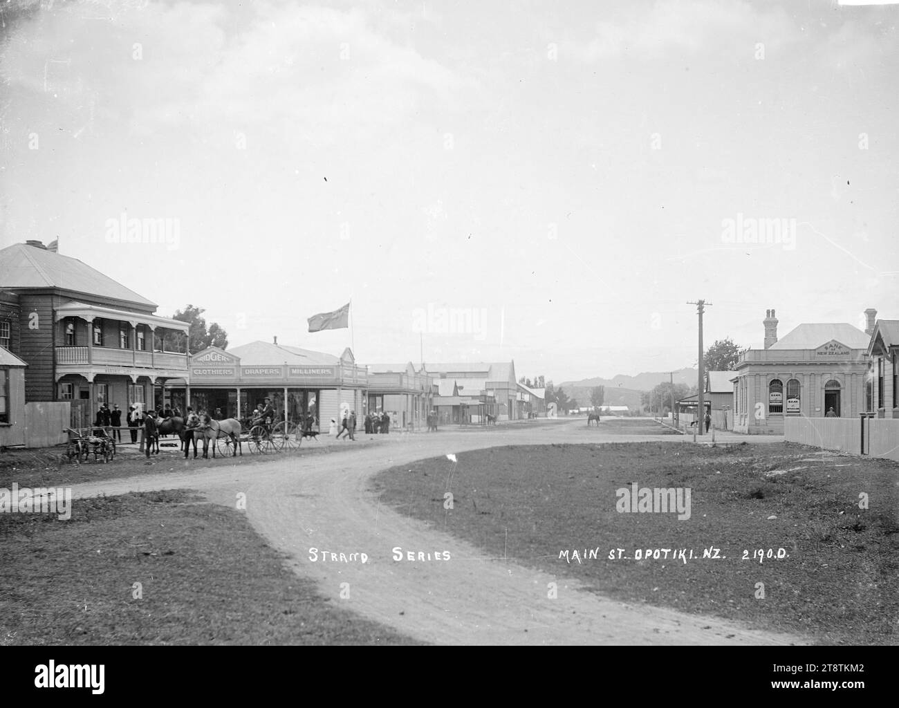 Main Street, Opotiki, View looking down Main Street (now known as Elliot Street) with the Masonic Hotel on the left at intersection with Church Street; on the opposite corner are the premises of Bridgers Ltd (drapers); across the road on the opposite corner is the Bank of New Zealand. A horse and carriage is outside the Masonic Hotel. in early 1900s Stock Photo