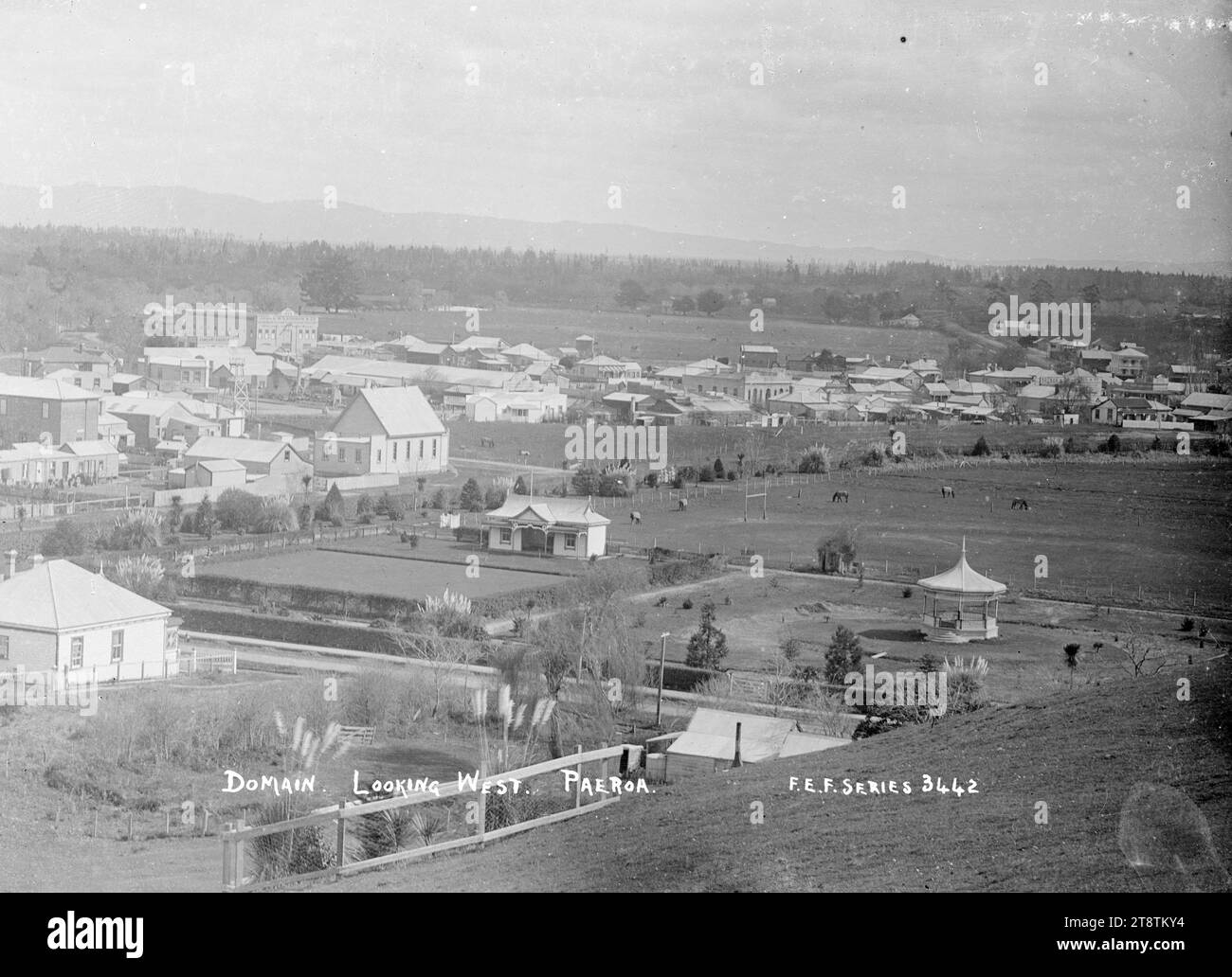Paeroa Domain, looking West, ca 1918 - Photograph taken by Fred. E Flatt, View over the Paeroa Domain, looking West. Photograph taken by F.E.F. (probably Fred E Flatt, stationer, at Paeroa in 1918). There is a bandstand in the right foreground, with a bowling club and bowling green to the left of the band rotunda. The township is beyond, with the business premises of James McAndrew, timber merchants, in the left background Stock Photo
