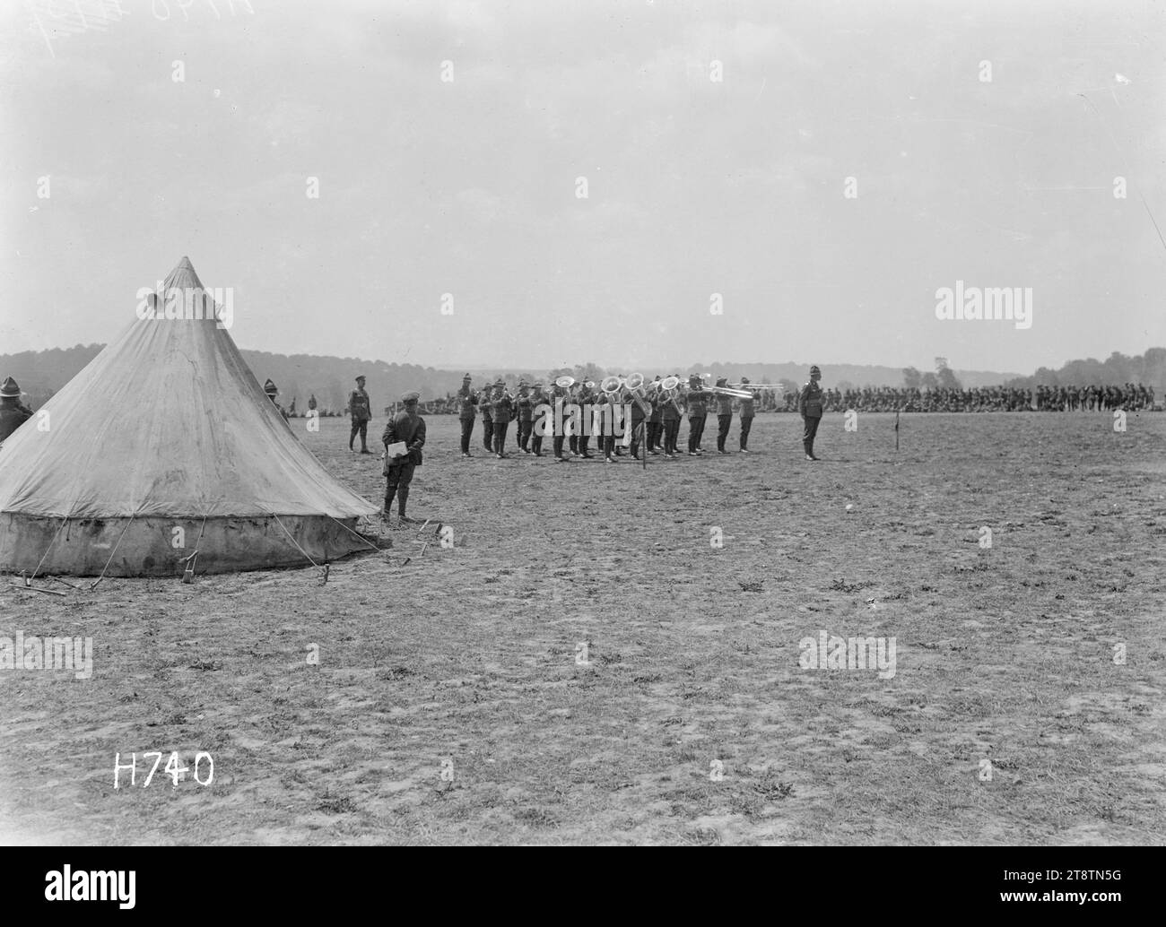 The judges tent at the New Zealand Divisional Band Contest, Authie, France, The judge's tent at the New Zealand Divisional Band Contest held in Authie during World War I. Beyond it a band plays before the judge who stands outside the tent. Photograph taken 27 July 1918 Stock Photo