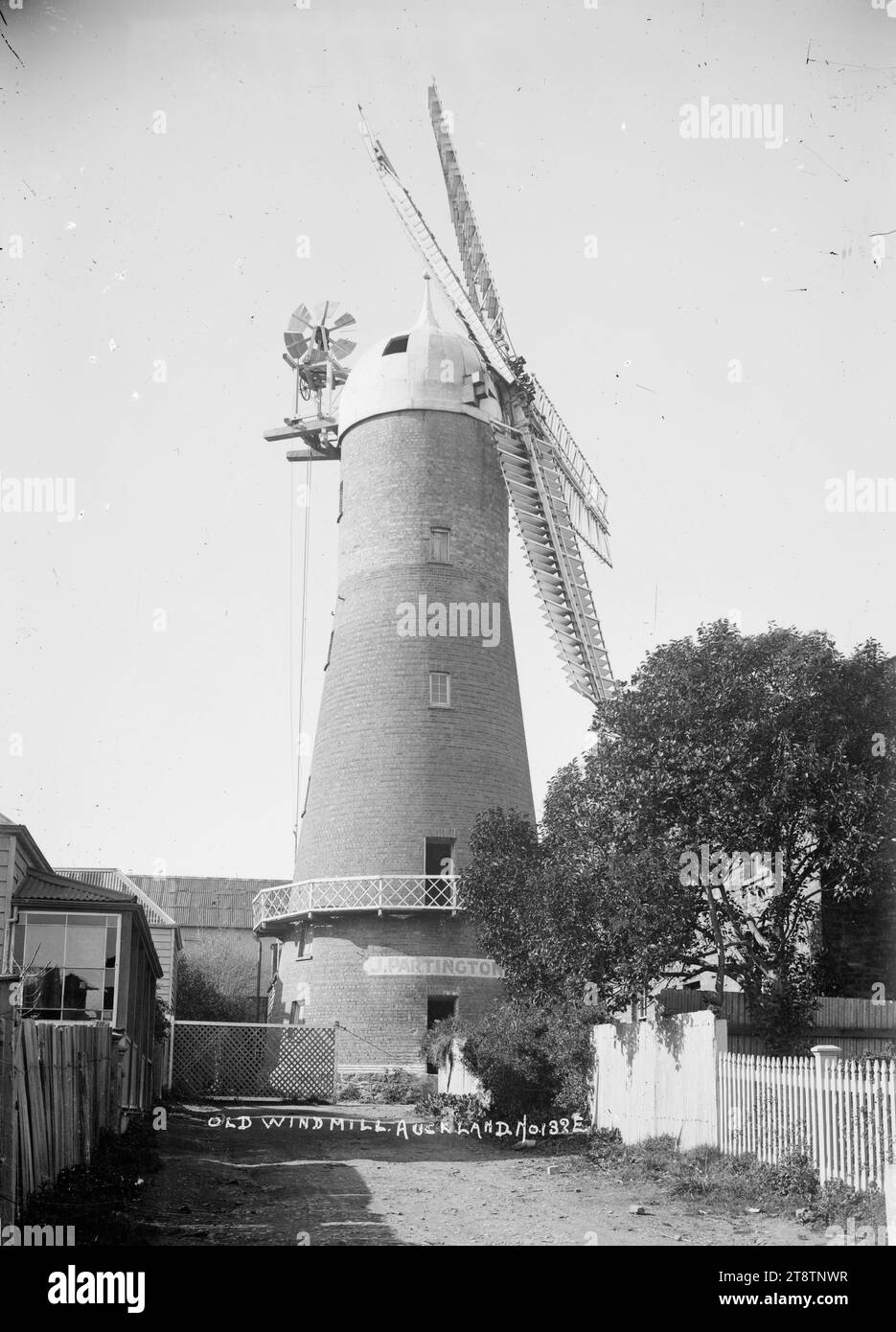 Partington's Mill, Auckland, New Zealand, View of flour mill owned by Joseph Partington. Photograph taken looking up a lane leading to the windmill in early 1900s. The sails are on the right Stock Photo
