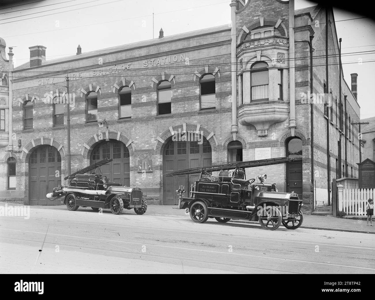 City Fire Brigade Station, Auckland, New Zealand with fire engines parked outside, View of the City Fire Brigade Station. Two Auckland, New Zealand Fire Brigade engines are parked on the roadside in front of the station, ca 1920 Stock Photo