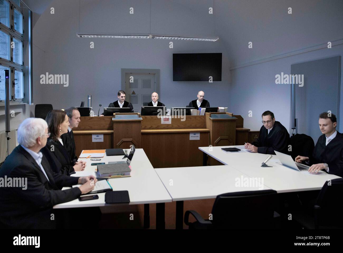 21 November 2023, Berlin: Jürgen Resch (l-r), Managing Director of Deutsche Umwelthilfe (DUH), Juliane Schütt, lawyer, Tobias Bulling, lawyer, and Holger Thiel (M), judge in the case, sit in the courtroom before the start of the hearing of DUH's landmark lawsuit against US internet giant Meta (Facebook, Instagram) at Berlin Regional Court. The lawsuit is based on threats of violence and murder in public Facebook groups. Resch is demanding that the Facebook parent company close certain groups and is attempting to enforce this with a model lawsuit. Photo: Carsten Koall/dpa Stock Photo