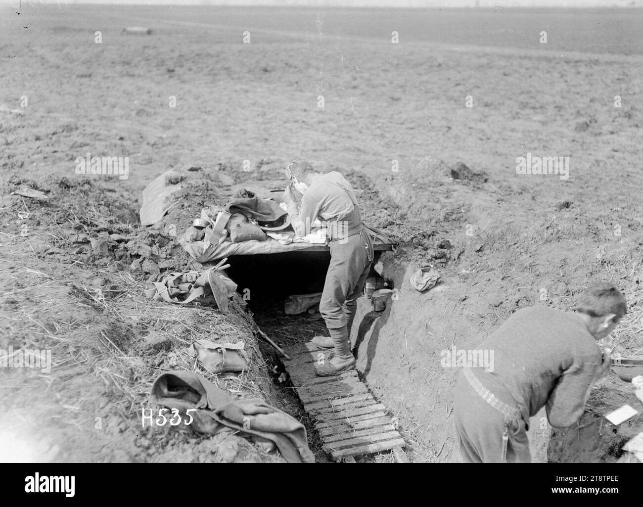 Early morning toilet in the New Zealand support lines, France, A soldier standing outside his funk hole shaves in the early morning near Colincamps where New Zealand support lines were established during World War I. Photograph taken 21 April 1918 Armytage Sanders Stock Photo