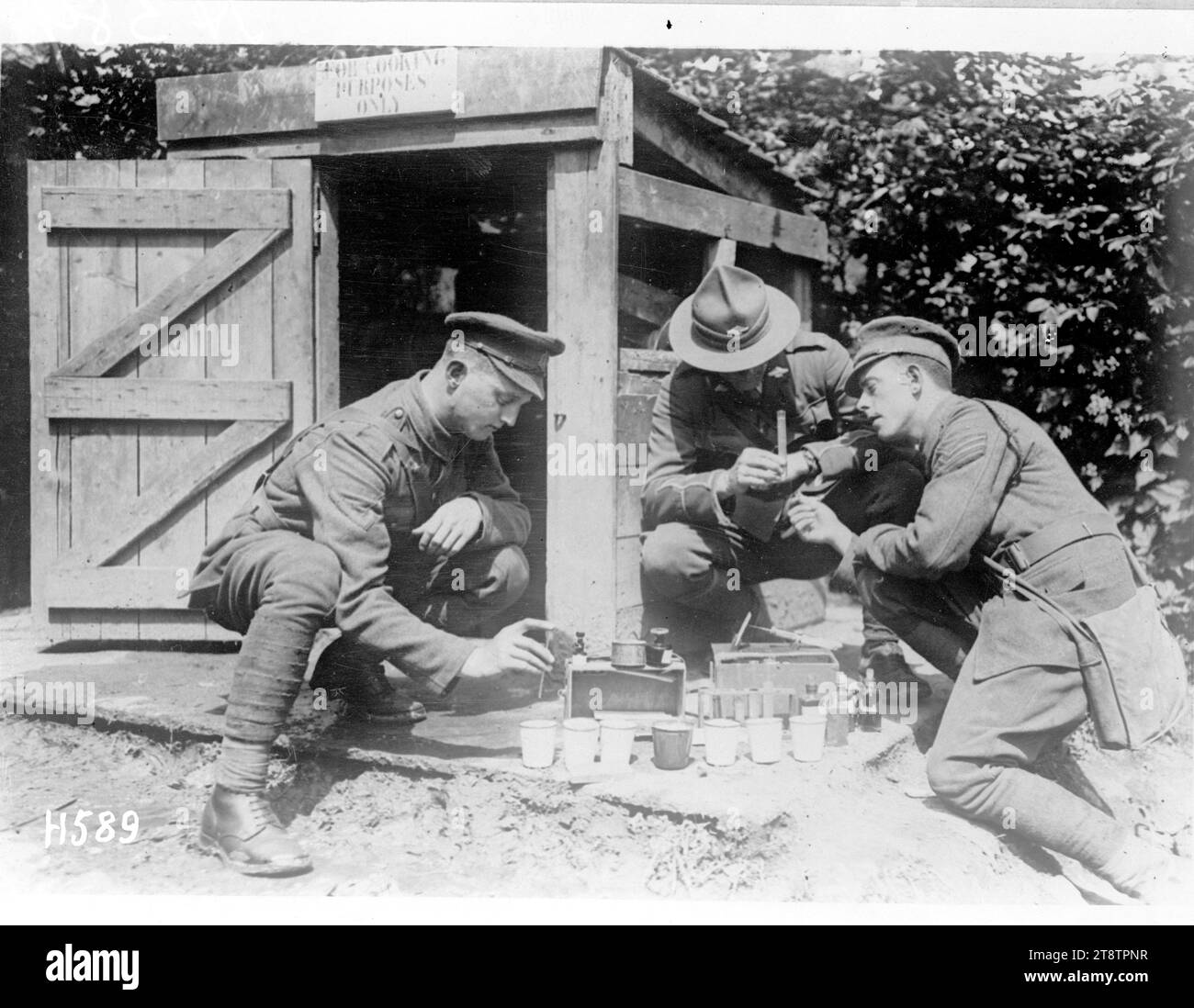 Testing water supply points in France during World War I, Soldiers carrying out a regular test on water points to check for organic or chemical poisoning near the Somme. Photograph taken Bertrancourt 15 May 1918 Stock Photo