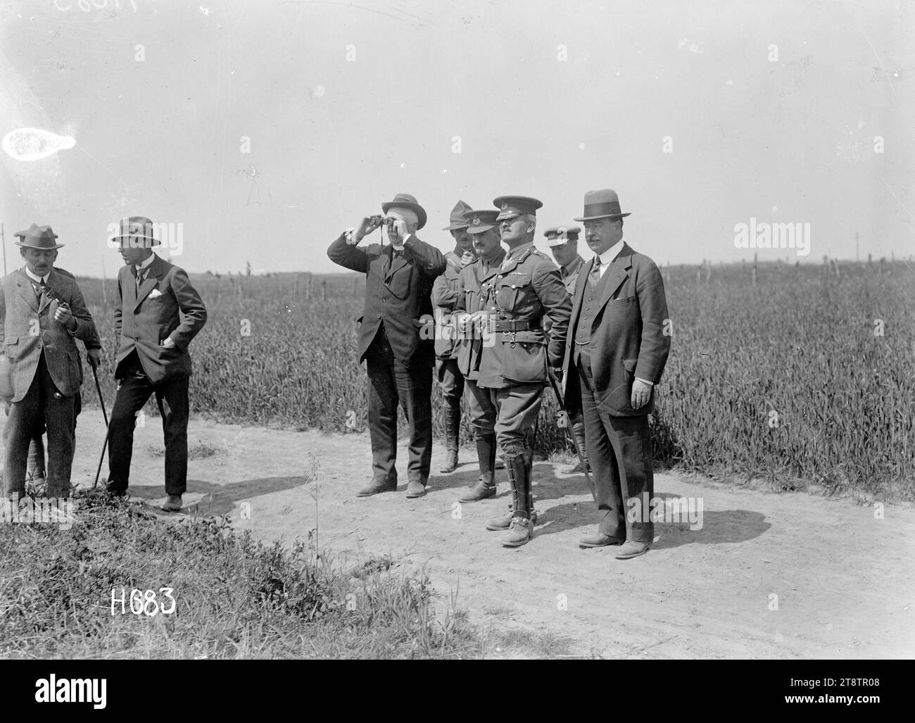 Prime Minister William Massey and Sir Joseph Ward observe New Zealand troop exercises, Bois-de-Warnimont, France, Prime Minister William Massey and Sir Joseph Ward observe tactical exercises of New Zealand troops at Bois-de-Warnimont in France during World War I. Massey watches through binoculars and Ward stands at far right. Photograph taken 30 June 1918 Stock Photo