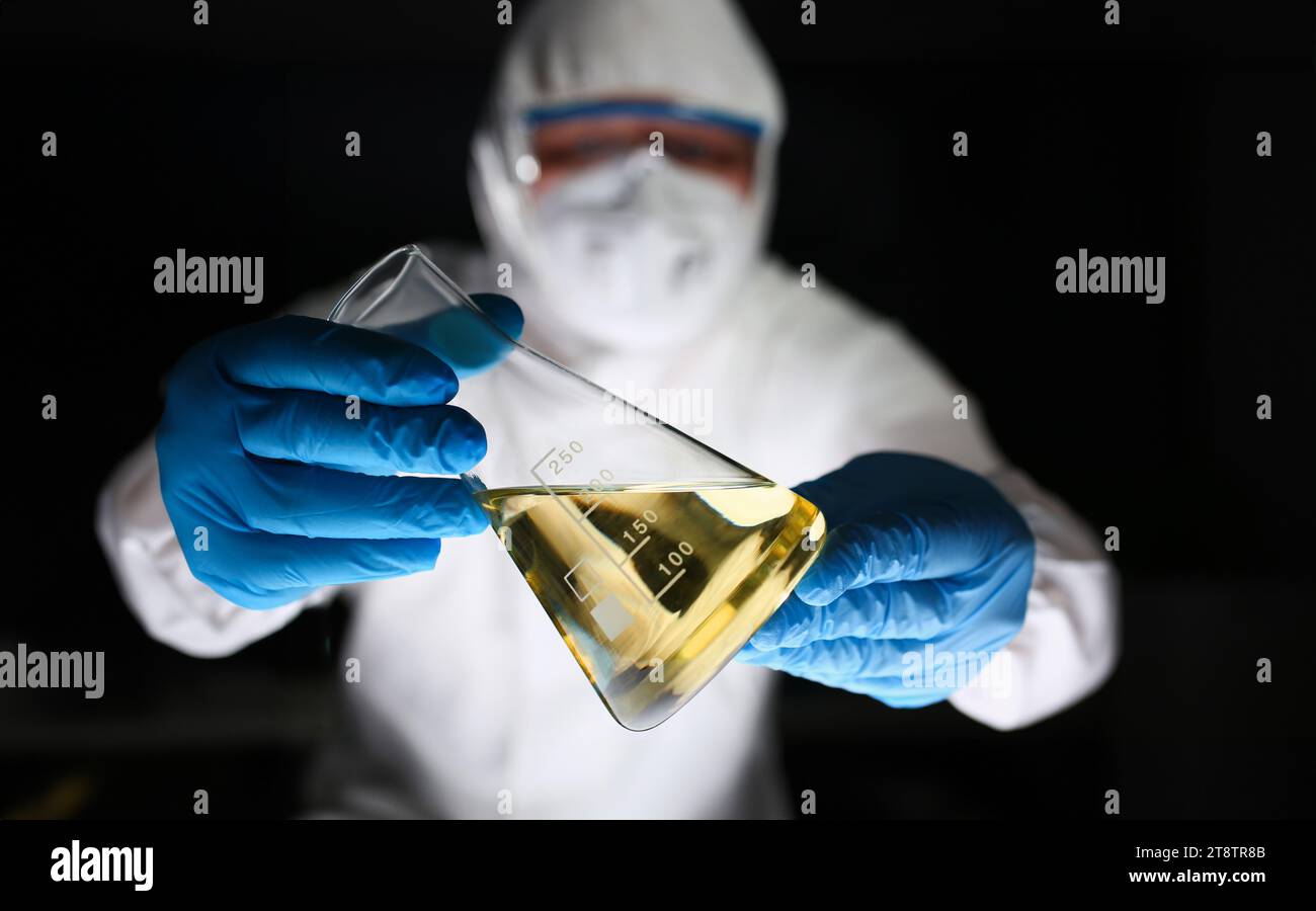 Male chemist look at microscope hold test tube Stock Photo