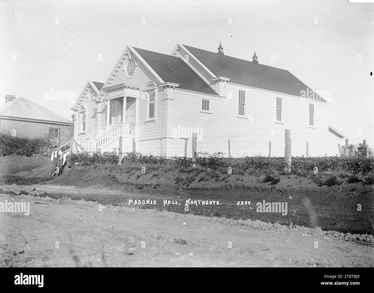 View of the Masonic Hall, Northcote, Auckland, New Zealand, View of the Masonic Hall with two men standing at the bottom of the steps leading up to the entrance. Taken ca 1910 Stock Photo